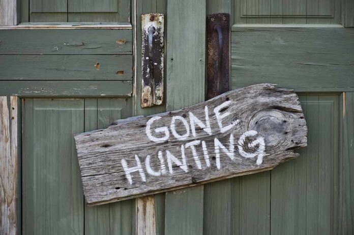 Weathered wooden sign on green door