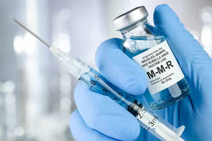 Gloved hands holding a vaccine vial and syringe