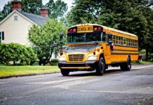 Runaway Bus Smashes Brooklyn Home Yellow school bus driving on a suburban street