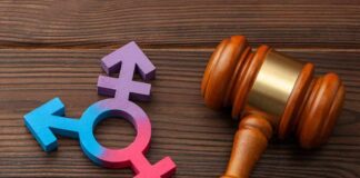 New Poll Puts Trans Sports Debate Spotlight Wooden gavel beside multicolored transgender symbol
