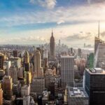 Price Shock: NYC Youth Flee South Aerial view of New York City skyline featuring the Empire State Building at sunset
