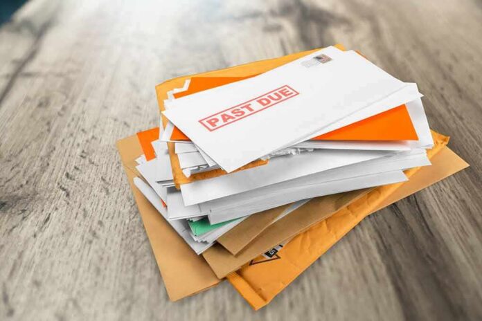 Stack of mail with past due notice on top