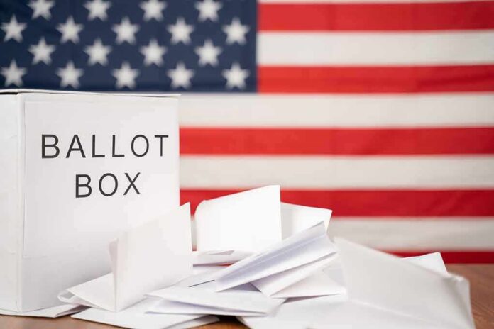 Ballot box with papers in front of an American flag