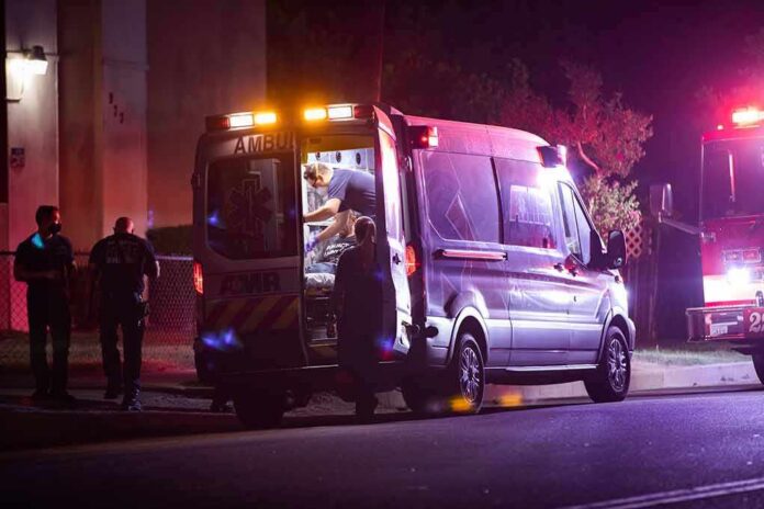 shutterstock_1842250744 Ambulance at night with paramedics attending a patient
