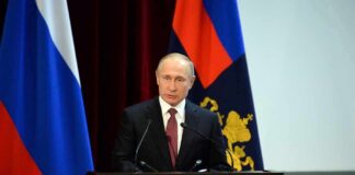 Putin’s Next Move Terrifies Analysts speaker at podium with flags in background