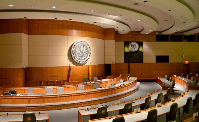 shutterstock_190351604 Interior view of a government chamber with wooden paneling and seating