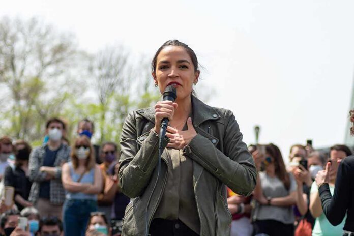woman speaking into a microphone at an outdoor rally