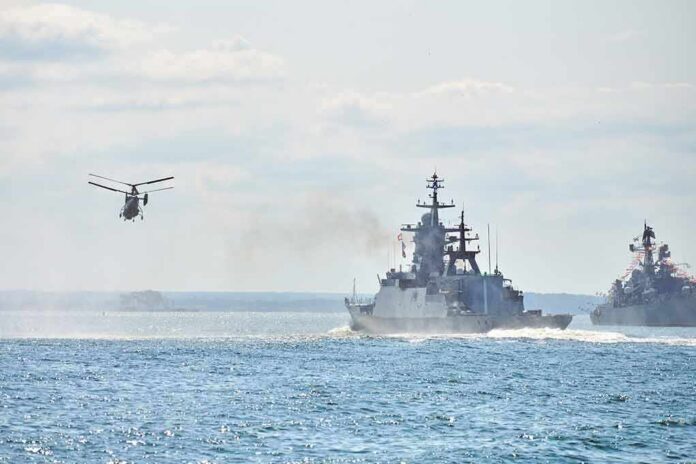 shutterstock_2060995196 military ships and helicopter at sea