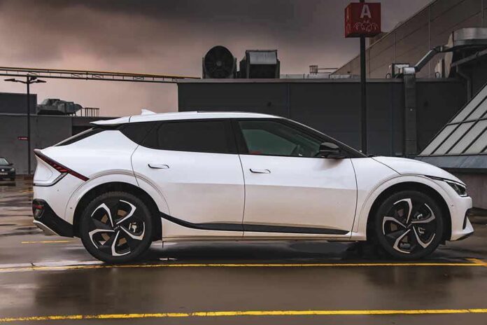 shutterstock_2100771958 white electric crossover parked on rooftop in side profile