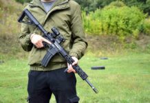 Talarico Invokes God In AR-15 Debate person holding a black rifle outdoors