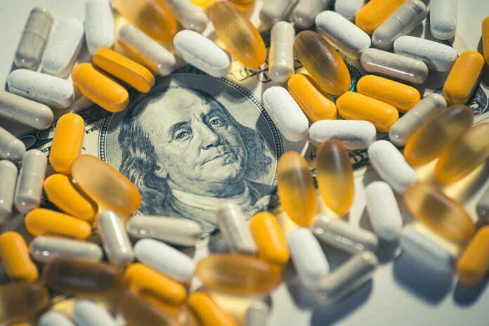 pills and capsules scattered over a hundred-dollar bill