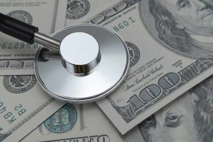 shutterstock_2150993969 Stethoscope on US dollar bills