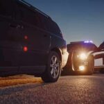 Officer Charged in Wrong-House Shooting Police officer at patrol car during traffic stop at dusk