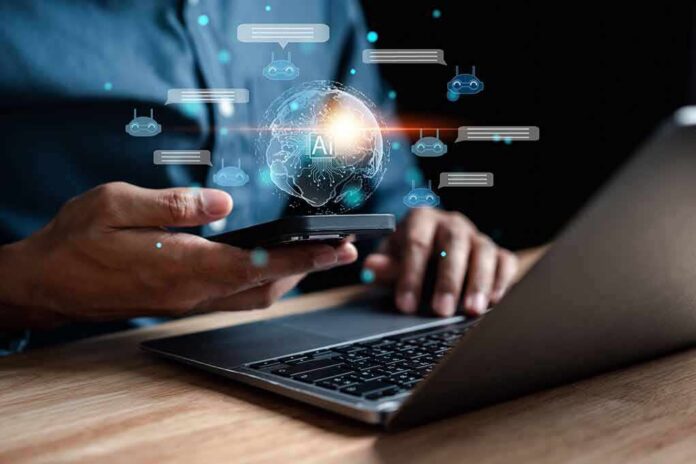 shutterstock_2249571297 Person using smartphone and laptop with AI hologram