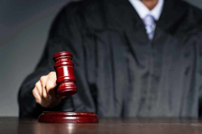 shutterstock_2250387095 Judge with gavel striking sound block