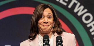 Kamala’s $20K VIP Night Sparks Fury woman at podium with two microphones