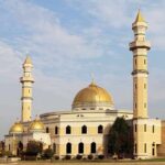 Noise War Explodes In Michigan Mosque with golden dome and two tall minarets under a partly cloudy sky
