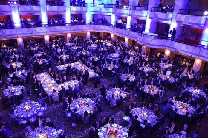 shutterstock_331235918 Ballroom filled with round tables at a formal gala dinner