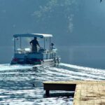 Repeat DUI Suspect Killed Former Marine Two people on a boat navigating a misty lake