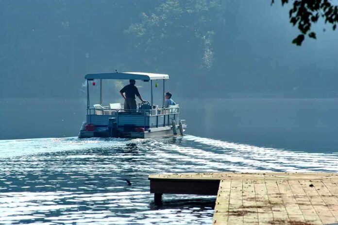 shutterstock_507843 Two people on a boat navigating a misty lake