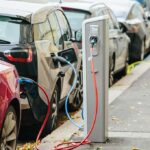 Electric cars charging at curbside stations
