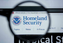 Election Panic: DHS Halted Nationwide Magnifying glass showing Homeland Security website.