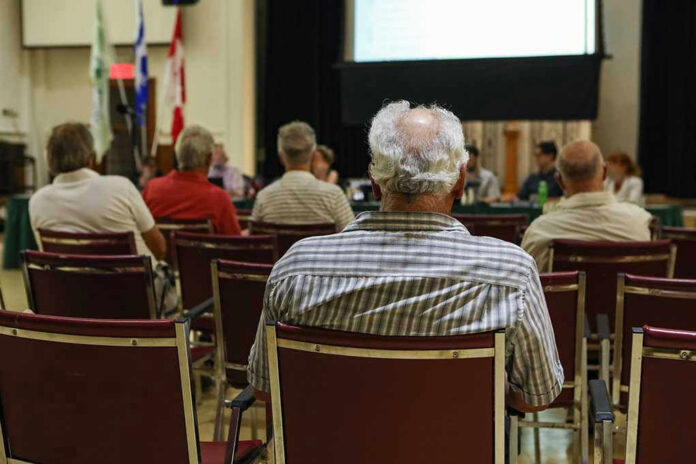 1521587657 Audience members seated facing a presentation screen