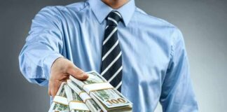 Family Payday Storm Hits Senate Hopeful Person in business attire offering bundles of US dollar bills