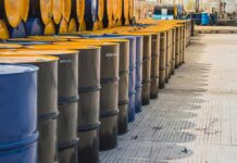 Defense Act Targets Fuel Shortage Rows of industrial metal barrels with yellow lids