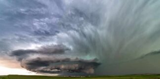 Hybrid Monster Targets I‑35 supercell thunderstorm over green prairie landscape