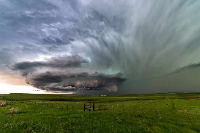 supercell thunderstorm over green prairie landscape