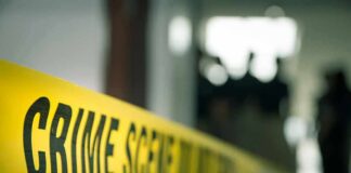 Pregnant Mom Torched – Child Watches crime scene tape in a blurred indoor setting
