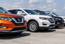 Row of Nissan SUVs parked at a car dealership