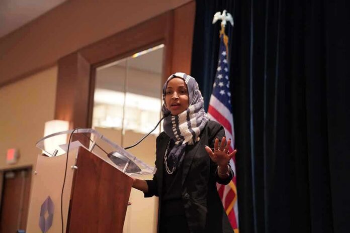shutterstock_1397740550 Ilhan Omar speaking at a podium with a microphone