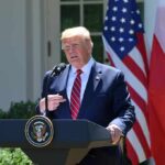 Diesel Tax Holiday Shocks Highways Donald Trump speaking at a podium with U.S. and Polish flags behind him