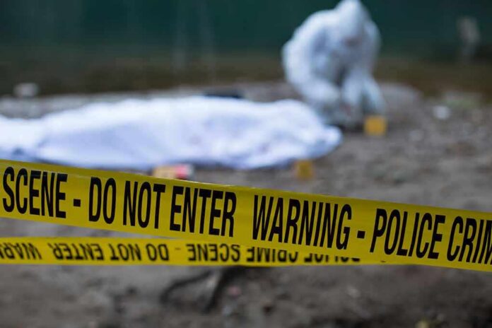 Crime scene with police tape and forensic investigator