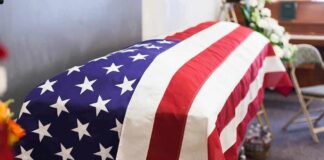American flag-draped casket at a funeral service