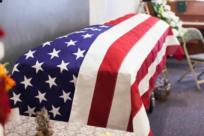 shutterstock_1501758101 American flag-draped casket at a funeral service