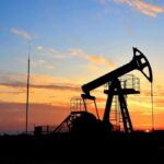 Oil pumpjack silhouette at sunset