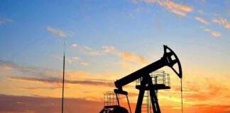 Oil pumpjack silhouette at sunset