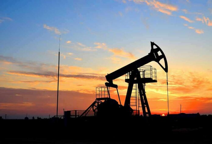Oil pumpjack silhouette at sunset