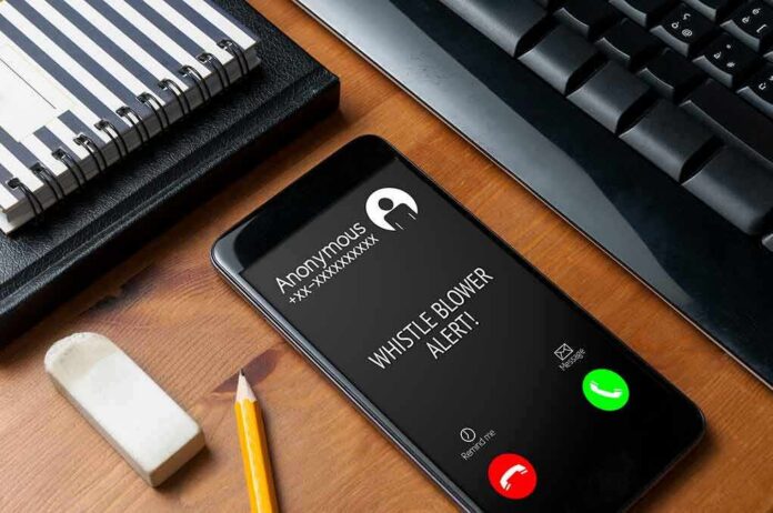 smartphone on desk showing an incoming anonymous call