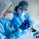 Untreatable Diarrhea Threat Explodes Scientists in protective gear working with a syringe in a laboratory