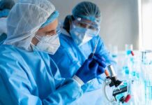 Untreatable Diarrhea Threat Explodes Scientists in protective gear working with a syringe in a laboratory