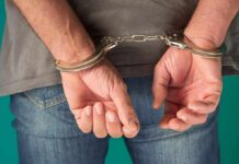 ICE Flags Four In Child Lure Bust person in handcuffs with hands behind back
