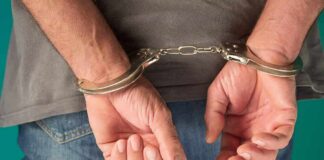 person in handcuffs with hands behind back