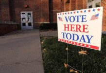 Fear Tactics Target Jewish Voters Voting sign outside a brick building entrance