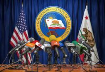 Press microphones at a podium before California governor seal