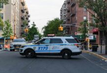 ICE Bullets Fly In NYC Rush Hour NYPD police SUV blocking a city street at a taped-off scene