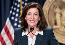 You Won’t Believe Who NY Gov Blames for NY Antisemitism woman speaking at a podium with microphones